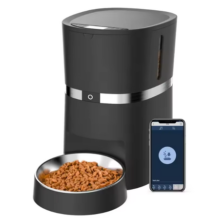 Pet feeder unboxed with all included accessories: bowl, food container, manuals, desiccant bag, and power adapter